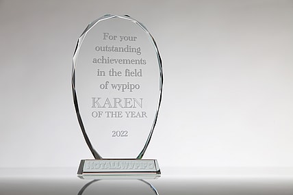 A clear acrylic award reading "For your outstanding achievements in the field of wypipo, Karen of the Year 2022"