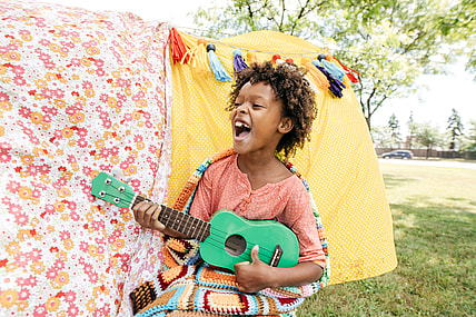 A child playing a toy guitar