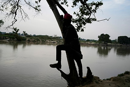 Man stands on the banks of the Yobe river in Nigeria