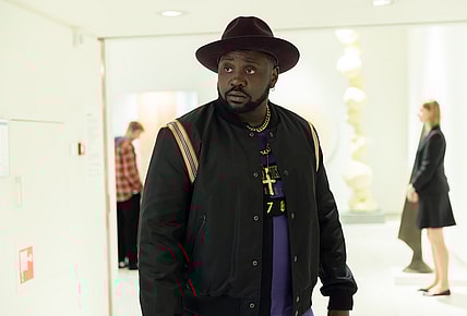Actor Brian Tyree Henry in a black jacket and hat portrays Alfred "Paper Boi" Miles in "Atlanta"