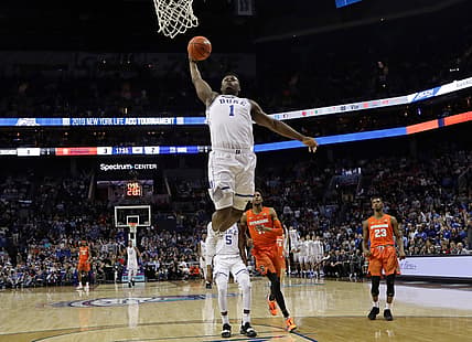 Duke's Zion Williamson (1) goes up to dunk against Syracuse during the first half of an NCAA college basketball game in the Atlantic Coast Conference tournament in Charlotte, N.C., Thursday, March 14, 2019. (AP Photo/Chuck Burton)