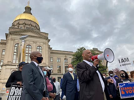 Bishop Reginald Jackson speaks through a bullhorn