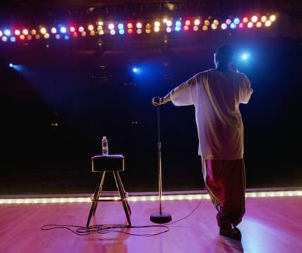 A man on stage facing the audience