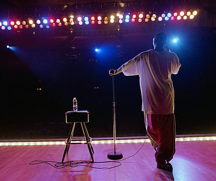 A man on stage facing the audience