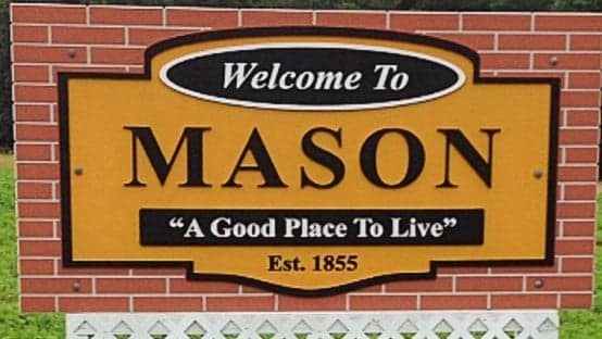 A brick sign reading "Welcome to Mason, A Good Place to Live"