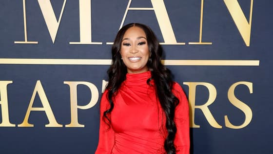 Melody Holt of OWN's "Love & Marriage: Huntsville" wears a long red dress and straight black hair to The Best Man event in Hollywood