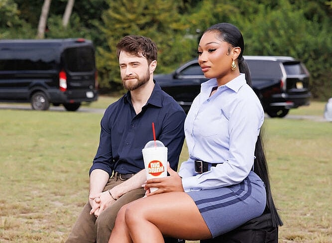 THE FALL AND RISE OF REGGIE DINKINS -- "You May Hug Your Hero" Episode 105 -- Pictured: (l-r) Daniel Radcliffe as Arthur Tobin, Megan Thee Stallion as Denise -- (Photo by: Hot Girl Productions)