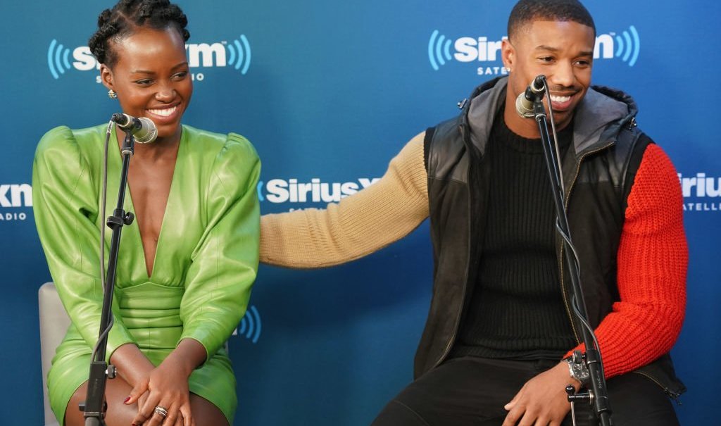 NEW YORK, NY - FEBRUARY 13: Lupita Nyong'o and Michael B. Jordan take part in SiriusXM's Town Hall with the cast of Black Panther hosted by SiriusXM's Sway Calloway on February 13, 2018 in New York City. (Photo by Cindy Ord/Getty Images for SiriusXM) thegrio.com