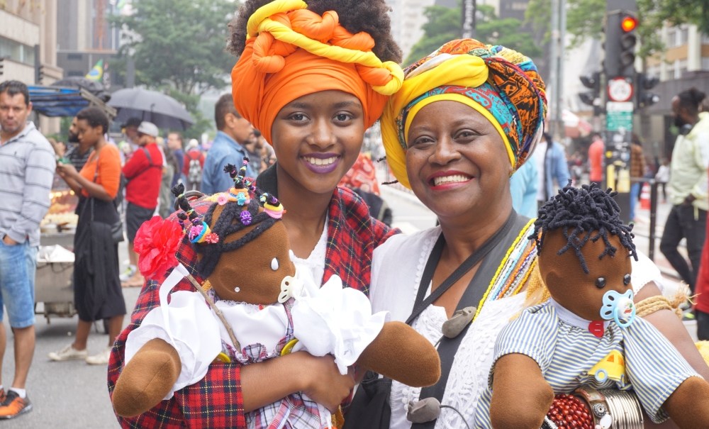 Black Consciousness Day Parade in São Paulo. She was just one-year-old when her grandmother brought her to her first parade. These days, dressed traditionally in headwraps and long skirts, she and her grandmother are seen at the annual event carryin thegrio.com