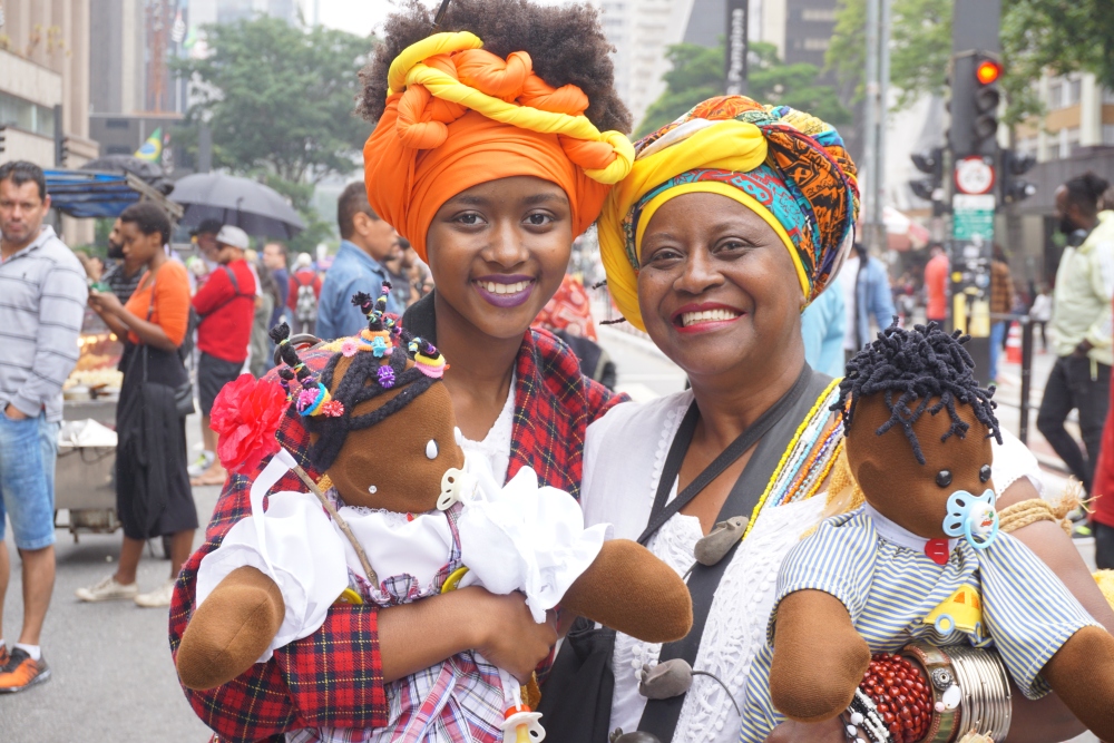 Black Consciousness Day Parade in São Paulo. She was just one-year-old when her grandmother brought her to her first parade. These days, dressed traditionally in headwraps and long skirts, she and her grandmother are seen at the annual event carryin thegrio.com