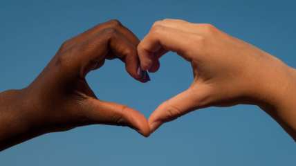 Black and white hands in heart shape, interracial thegrio.com
