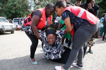 Kenya Red Cross personnel helps a woman who collapsed , Wednesday, Jan. 16 2019 at Chiromo Mortuary, after learning of a family member who was killed during terrorist attack on Tuesday. An upscale hotel complex in Kenya's capital came under attack on Tuesday, with a blast and heavy gunfire. The al-Shabab extremist group based in neighboring Somalia claimed responsibility and said its members were still fighting inside (AP Photo/Brian Inganga) thegrio.com