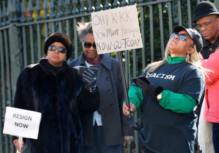 Tara Raigns, of Petersburg, Va., right, reacts to Gov. Ralph Northam's comments during a news conference in the Governor's Mansion in Richmond, Va., on Saturday, Feb. 2, 2019. She joined protesters outside, calling for his resignation. (Alexa Welch Edlund/Richmond Times-Dispatch via AP) thegrio.com