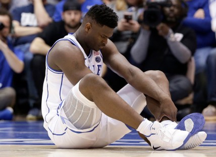 Duke's Zion Williamson sits on the floor following a injury during the first half of an NCAA college basketball game against North Carolina in Durham, N.C., Wednesday, Feb. 20, 2019. (AP Photo/Gerry Broome) thegrio.com