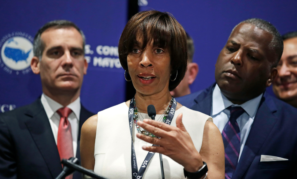 Baltimore Mayor Catherine Pugh addresses a gathering during the annual meeting of the U.S. Conference of Mayors in Boston, Friday, June 8, 2018. More than 250 city executives gathered to discuss their concerns including infrastructure, school safety, immigration and the economic future of cities. With Pugh are Los Angeles Mayor Eric Garcetti, left, and Columbia, SC Mayor Steve Benjamin. (AP Photo/Charles Krupa) thegrio.com