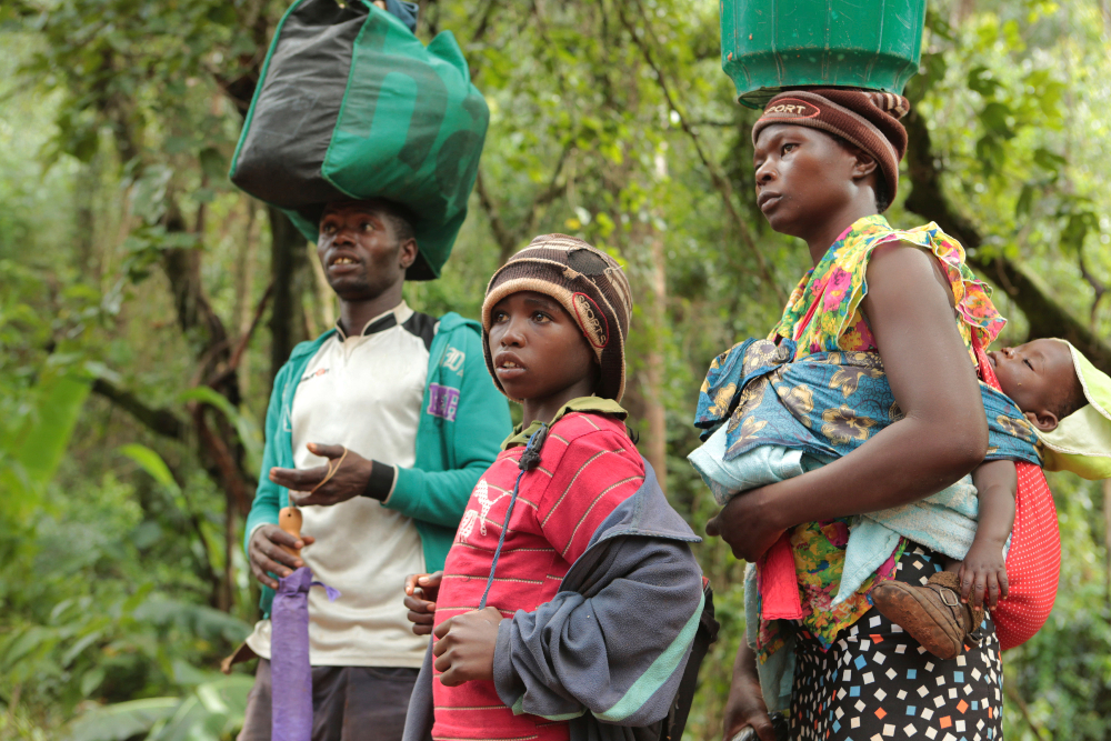 Luckymore Rusero and his family walk past a collapsing road in Chimanimani about 600 kilometres south east of Harare, Zimbabwe, Monday, March, 18, 2019. Rusero said he walked for more than 20 kilometres from one of the hardest hit areas to safety. According to the government Cyclone IDAI has killed more than 80 people although residents in Chipinge and Chimanimani say the figure could be higher becuase the hardest hit areas are still inaccesible. Desperate people walked for several kilometres to reach safety carrying whatever few belongings they could(AP Photo/Tsvangirayi Mukwazhi) thegrio.com