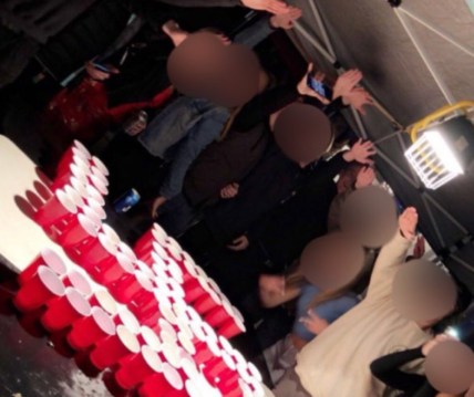 This image from Twitter shows Newport-Mesa students toasting over a swastika made from red plastic cups. The "ultimate rage" banner over the image was added by a social media user. (Twitter) thegrio.com