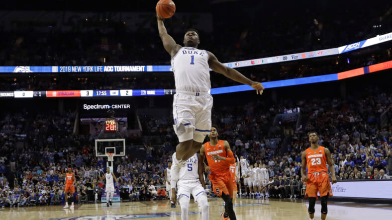 Duke's Zion Williamson (1) goes up to dunk against Syracuse during the first half of an NCAA college basketball game in the Atlantic Coast Conference tournament in Charlotte, N.C., Thursday, March 14, 2019. (AP Photo/Chuck Burton)