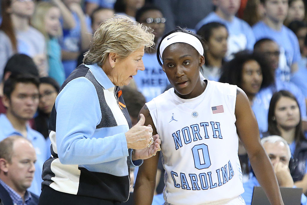 16 November 2014: UNC head coach Sylvia Hatchell (left) talks with Jamie Cherry (0). The University of North Carolina Tar Heels hosted the University of California Los Angeles Bruins at Carmichael Arena in Chapel Hill, North Carolina in a 2014-15 NCAA Division I Women's Basketball game. UNC won the game 84-68. (Photo by Andy Mead/YCJ/Icon Sportswire/Corbis via Getty Images) thegrio.com