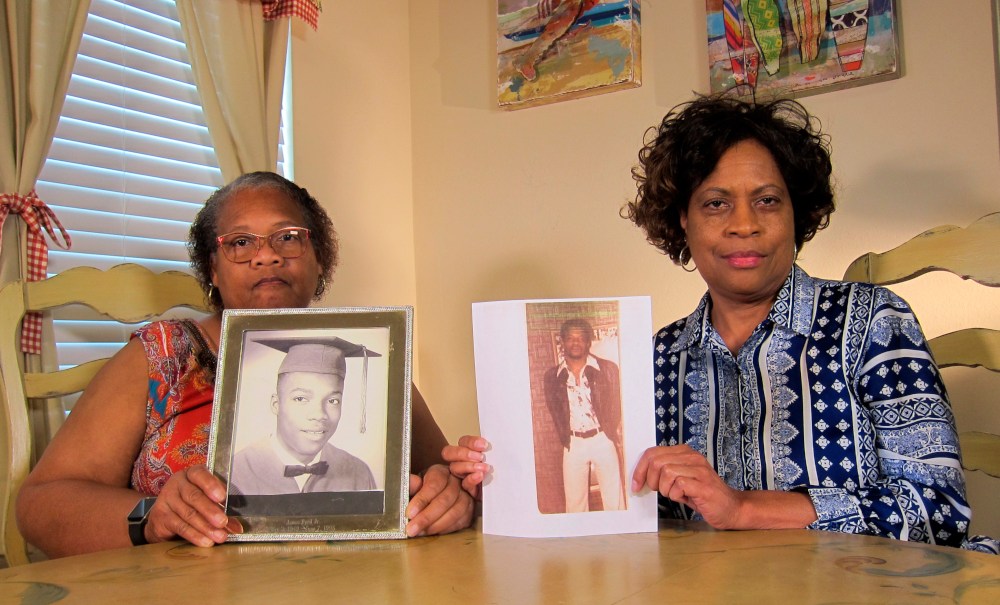 In this Wednesday, April 10, 2019, photo Mylinda Byrd Washington, 66, right, and Louvon Byrd Harris, 61, hold up photographs of their brother James Byrd Jr. in Houston. James Byrd Jr. was the victim of what is considered to be one of the most gruesome hate crime murders in recent Texas history. (AP Photo/Juan Lozano) thegrio.com