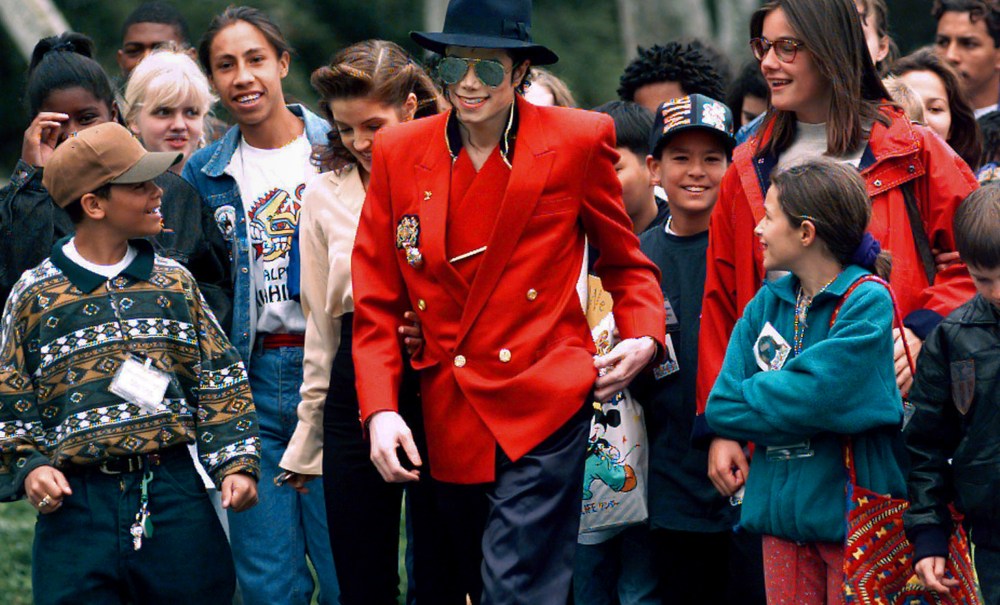 In this April 18, 1995, file photo, pop star Michael Jackson and Lisa Marie Presley, behind him at left, walk with children that were invited guests at his Neverland Ranch home in Santa Ynez, Calif. The co-executor of Jackson's estate says he's confident the late superstar's supporters will be able to protect his legacy and brand in the wake of HBO’s "Leaving Neverland," a documentary detailing allegations of sexual abuse. (AP Photo/Mark J. Terrill, File) thegrio.com