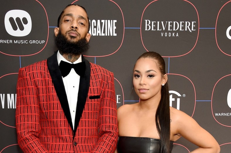 A fan of rapper Nipsey Hussle holds a sign as he attends a public