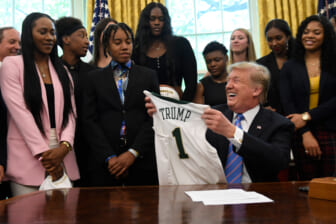 President Donald Trump holds up a jersey that was presented to him as he welcomed members of the Baylor women's basketball team, who are the 2019 NCAA Division I Women's Basketball National Champions, to the Oval Office of the White House in Washington, Monday, April 29, 2019. (AP Photo/Susan Walsh) thegrio.com