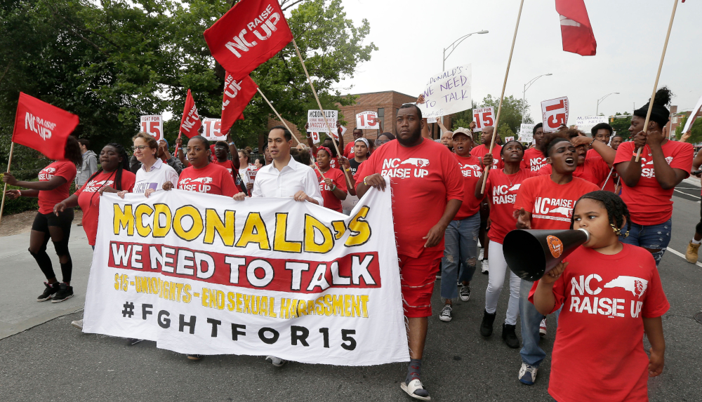 Presidential candidate and former U.S. Department of Housing and Urban Development Julian Castro rallies with McDonald's employees and other activists demanding fairer pay, better working conditions, and the right to unionize in Durham, N.C., Thursday, May 23, 2019. (AP Photo/Gerry Broome)