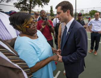 In this Wednesday, June 19, 2019 photo, South Bend Mayor and Democratic presidential candidate Pete Buttigieg shares a moment with Shirley Newbill, mother of Eric Logan, during a gun violence memorial at the Martin Luther King Jr. Recreation Center in South Bend, Ind. (Michael Caterina/South Bend Tribune via AP)