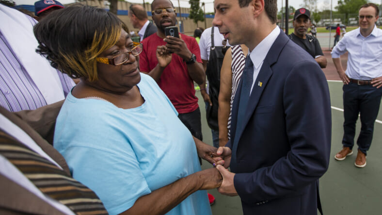 In this Wednesday, June 19, 2019 photo, South Bend Mayor and Democratic presidential candidate Pete Buttigieg shares a moment with Shirley Newbill, mother of Eric Logan, during a gun violence memorial at the Martin Luther King Jr. Recreation Center in South Bend, Ind. (Michael Caterina/South Bend Tribune via AP)