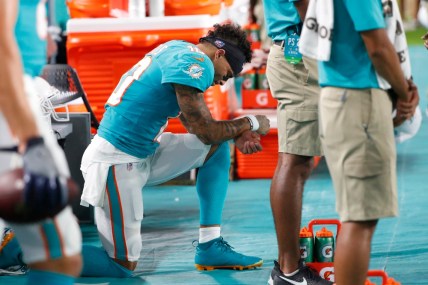 Miami Dolphins wide receiver Kenny Stills kneels during the singing of the National Anthem before the start of an NFL football preseason game against the Jacksonville Jaguars, Thursday, Aug. 22, 2019 in Miami Gardens, Fla. (AP Photo/Wilfredo Lee) thegrio.com