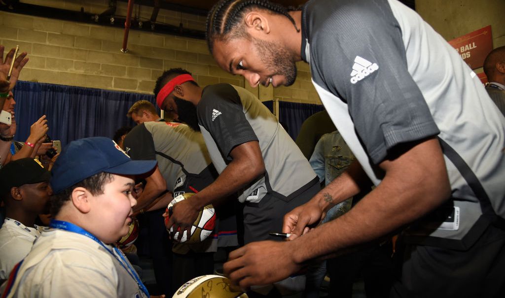 Kawhi Leonard signs autographs during the 66th NBA All-Star Game at Smoothie King Center on February 19, 2017 in New Orleans, Louisiana. (Photo by Kevin Mazur/Getty Images) thegrio.com