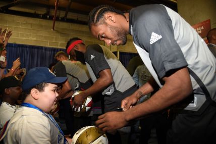 Kawhi Leonard signs autographs during the 66th NBA All-Star Game at Smoothie King Center on February 19, 2017 in New Orleans, Louisiana. (Photo by Kevin Mazur/Getty Images) thegrio.com