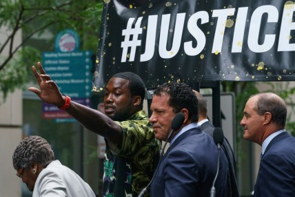 Meek Mill gestures at the crowd outside the Criminal Justice Center in Center City Philadelphia on Tuesday, Aug. 27, 2019. Mill pleaded guilty to a 2007 misdemeanor gun charge and won't serve additional time in prison after reaching a plea agreement in a case that's kept him on probation for most of his adult life. (Jessica Griffin/The Philadelphia Inquirer via AP) thegrio.com