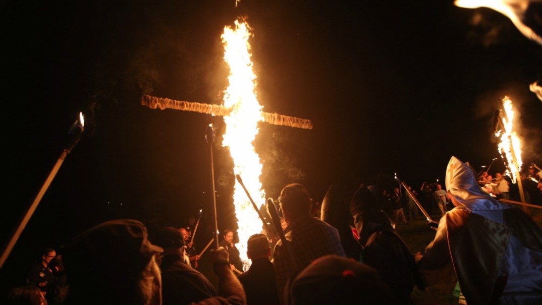 In this Saturday, April 23, 2016 photo, members of the Ku Klux Klan participate in cross burnings after a "white pride" rally in rural Paulding County near Cedar Town, Ga. (AP Photo/John Bazemore) thegrio.com