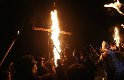 In this Saturday, April 23, 2016 photo, members of the Ku Klux Klan participate in cross burnings after a "white pride" rally in rural Paulding County near Cedar Town, Ga. (AP Photo/John Bazemore) thegrio.com