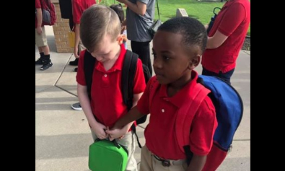 Courtney Coko Moore shared a photo of her son Christian comforting an autistic classmate and the photo soon went viral. (Courtney Coko Moore/Facebook) thegrio.com