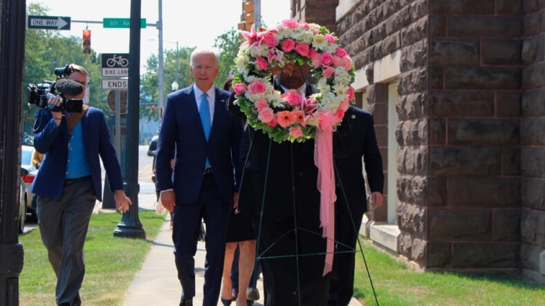 Former Vice President and presidential candidate Joe Biden, center left, joins Sen. Doug Jones and Birmingham Mayor Randall Woodfin at a wreath laying after a service at 16th Street Baptist Church in Birmingham, Ala., Sunday, Sept. 15, 2019. Visiting the black church bombed by the Ku Klux Klan in the civil rights era, Democratic presidential candidate Biden said Sunday the country hasn't "relegated racism and white supremacy to the pages of history" as he framed current tensions in the context of the movement's historic struggle for equality. (Ivana Hrynkiw/The Birmingham News via AP) thegrio.com