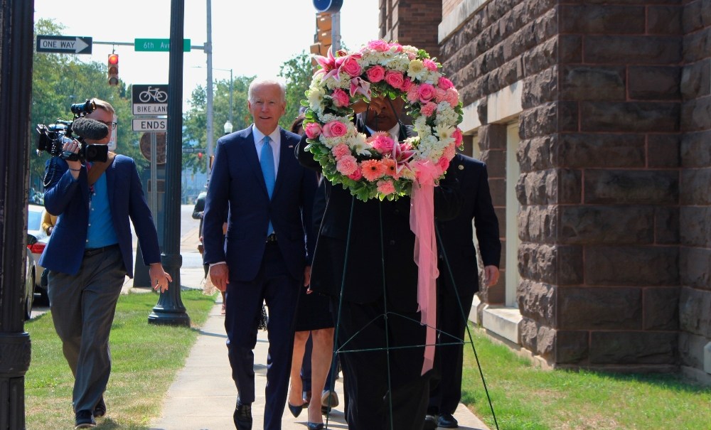 Former Vice President and presidential candidate Joe Biden, center left, joins Sen. Doug Jones and Birmingham Mayor Randall Woodfin at a wreath laying after a service at 16th Street Baptist Church in Birmingham, Ala., Sunday, Sept. 15, 2019. Visiting the black church bombed by the Ku Klux Klan in the civil rights era, Democratic presidential candidate Biden said Sunday the country hasn't "relegated racism and white supremacy to the pages of history" as he framed current tensions in the context of the movement's historic struggle for equality. (Ivana Hrynkiw/The Birmingham News via AP) thegrio.com