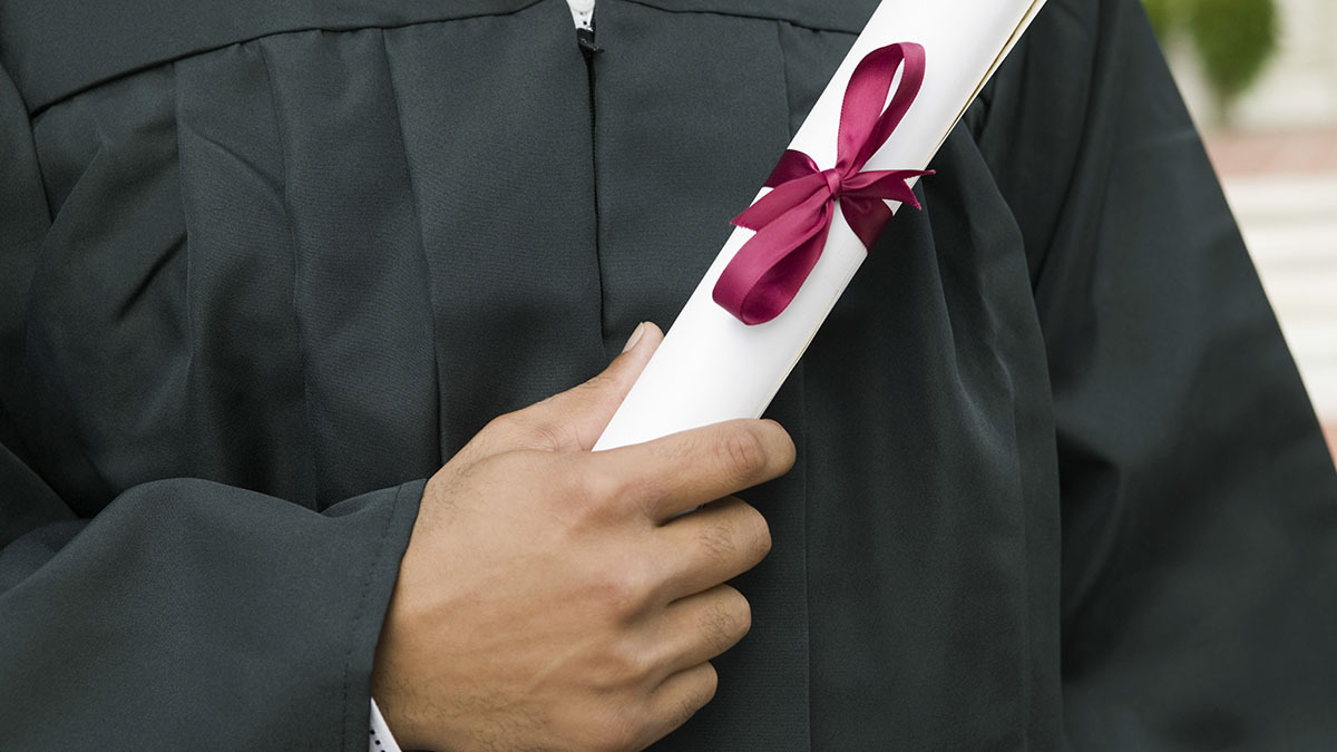 Student Holding Diploma theGrio.com