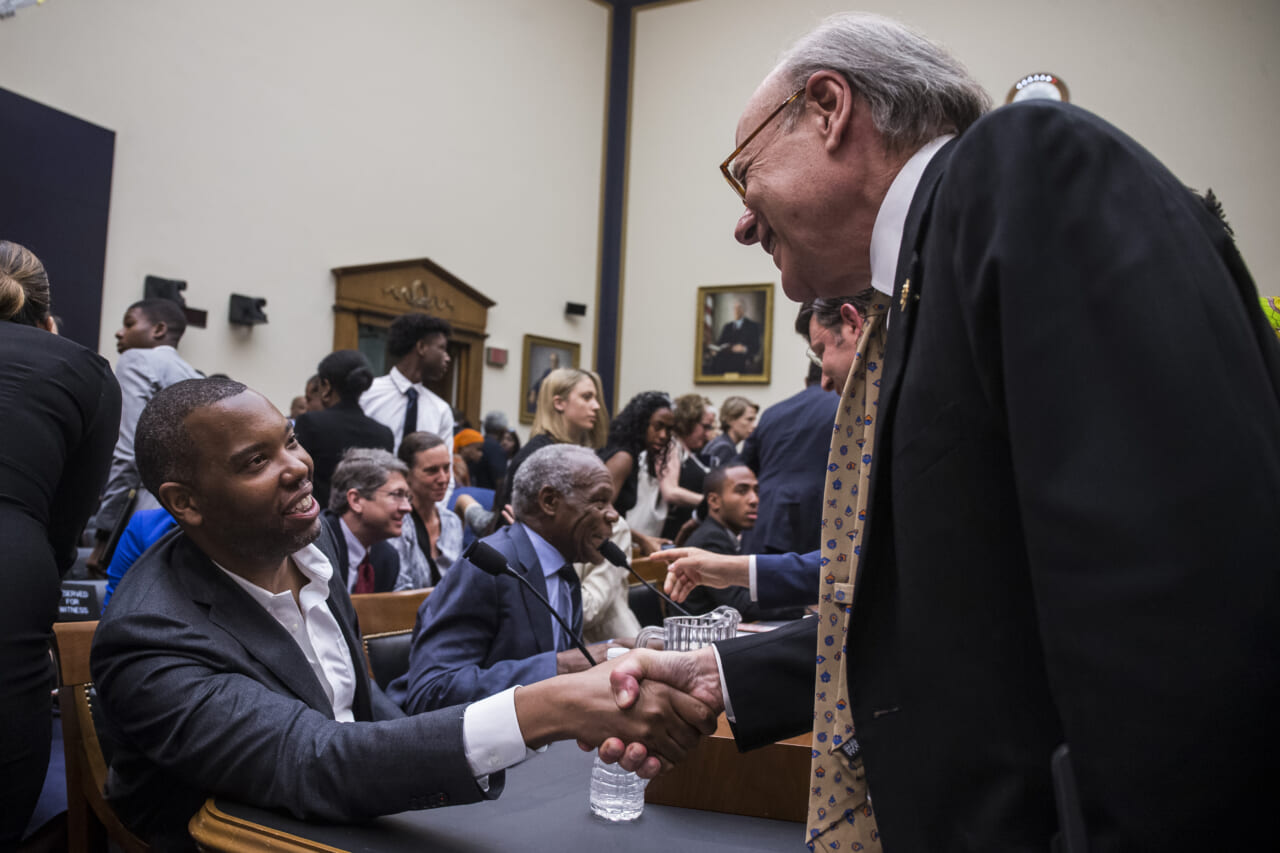 Two men shake hands