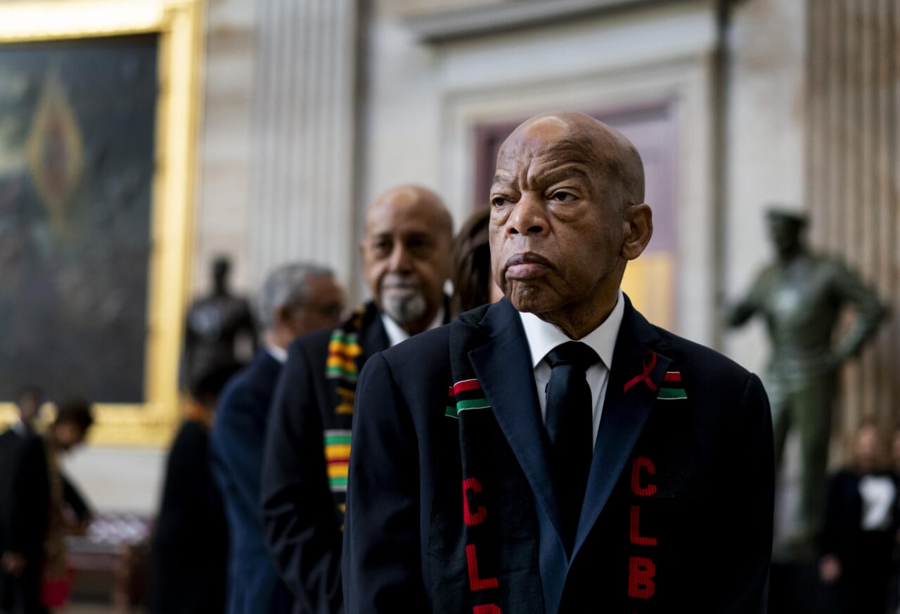 Rep. John Lewis stands solemnly, preparing to pay his respects to Rep. Elijah Cummings during a memorial ceremony in the Capitol's Statuary Hall in 2019.