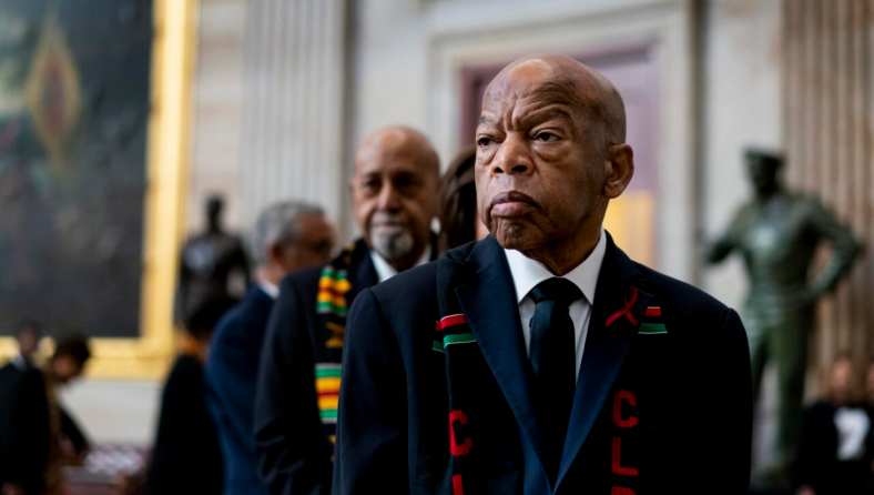 Rep. John Lewis stands solemnly, preparing to pay his respects to Rep. Elijah Cummings during a memorial ceremony in the Capitol's Statuary Hall in 2019.