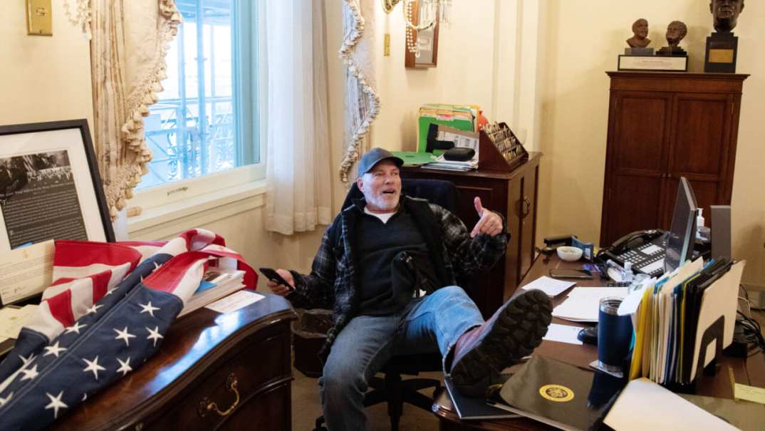 Richard Barnett with his foot on Speaker Nancy Pelosi's desk