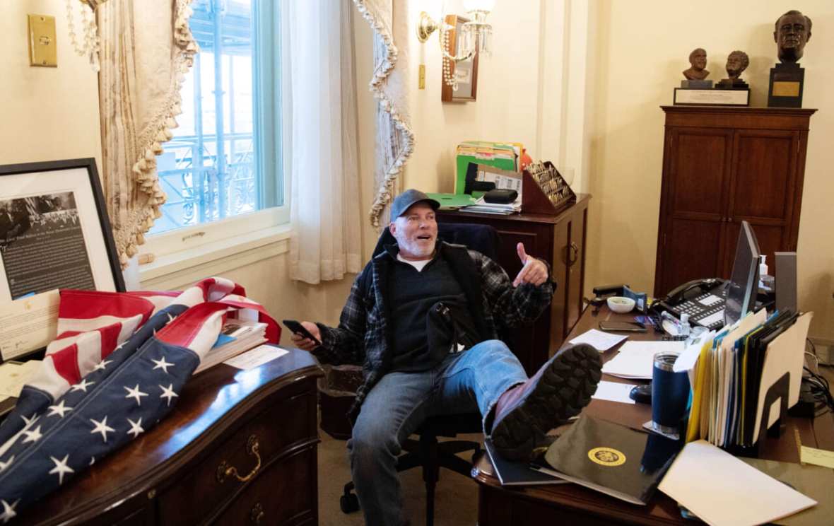 Richard Barnett with his foot on Speaker Nancy Pelosi's desk