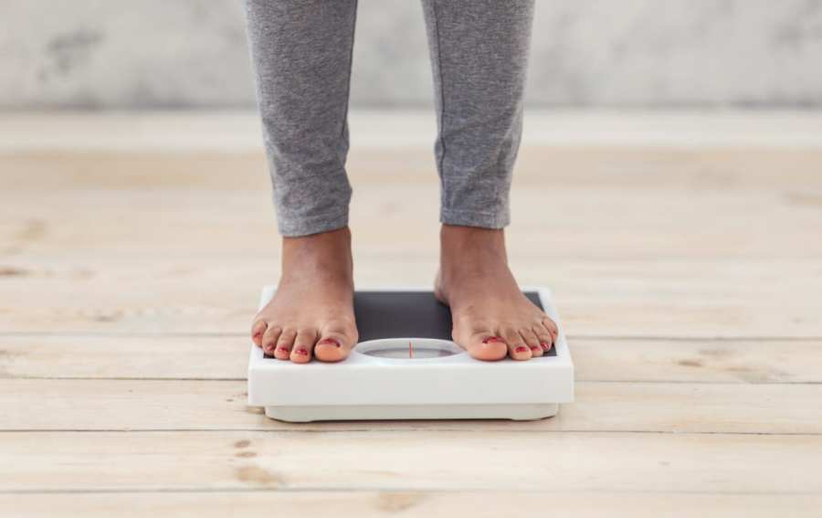 Black woman steps on weighing scale thegrio.com