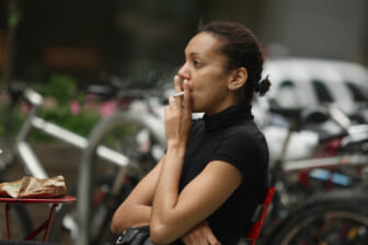 A woman smokes a cigarette
