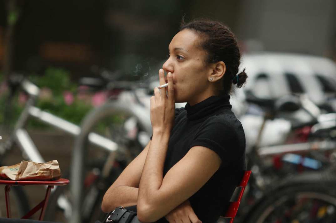 A woman smokes a cigarette