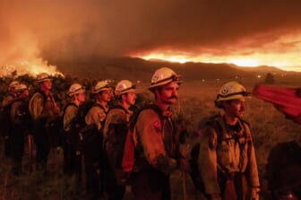 California wildfire advances as heat wave blankets US West