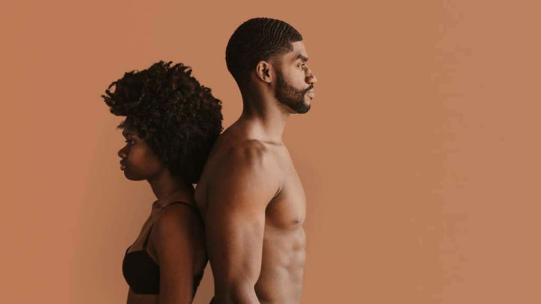 Shirtless Black couple with backs turned to each other, theGrio.com